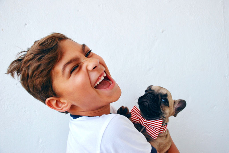 Happy young patient with his puppy in the waiting area